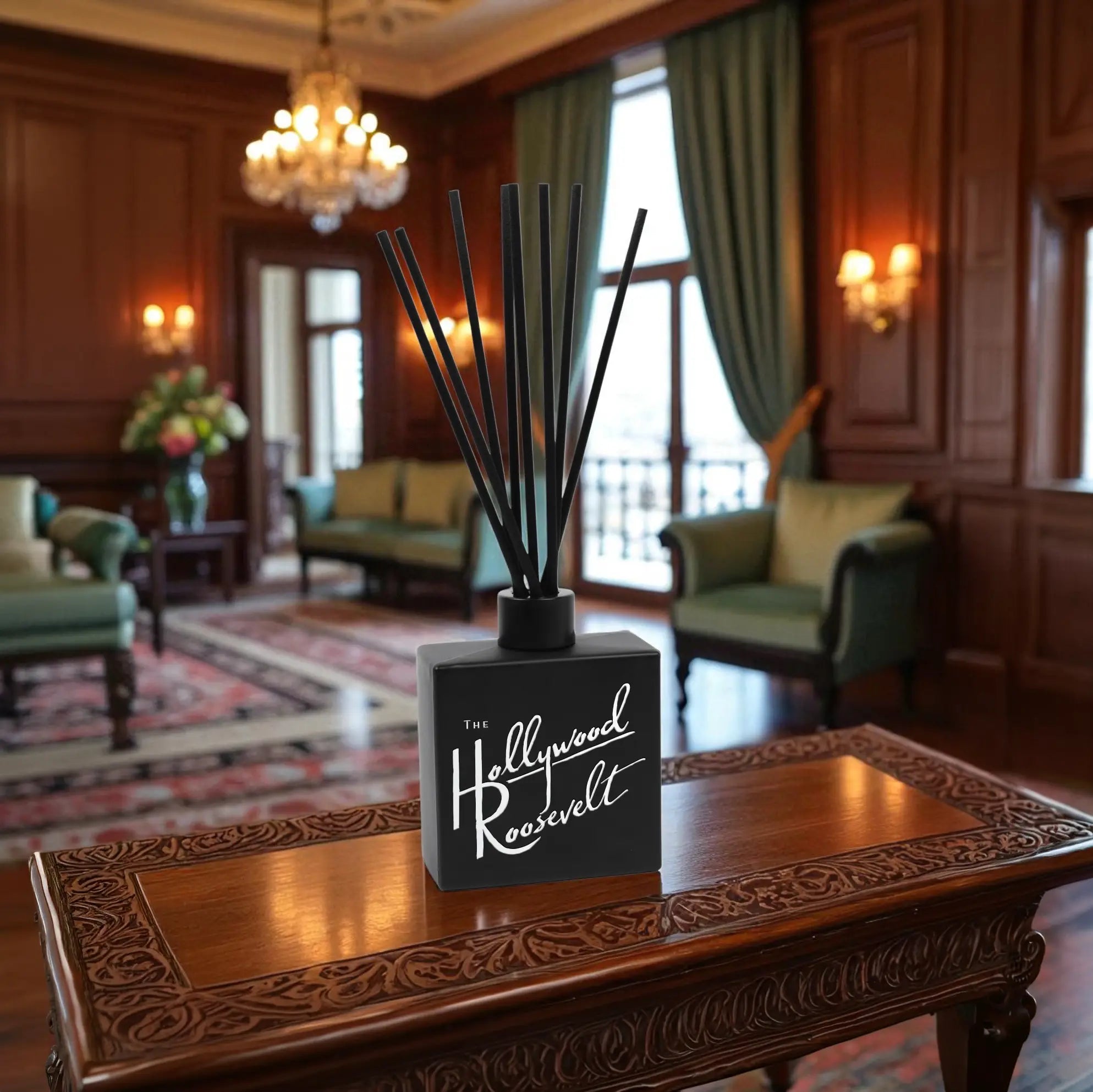 Clear 8oz Reed Diffuser with sticks on a wooden table in a luxurious room.