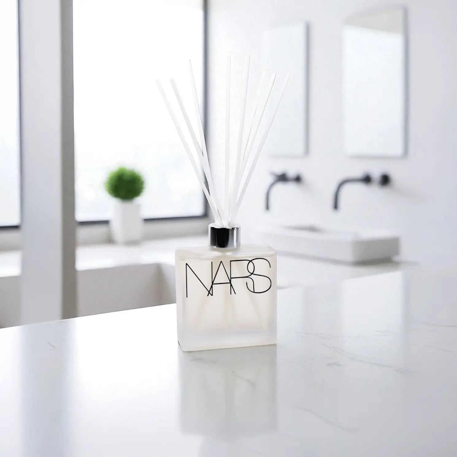 Frosted 8oz Reed Diffuser with blawhite sticks and branding on a bathroom background.