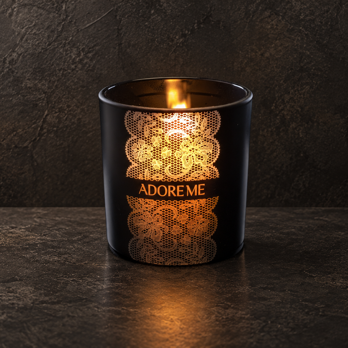 Matte Black 14 oz. Luxury Engraved Candle with a custom engraved logo, lit.