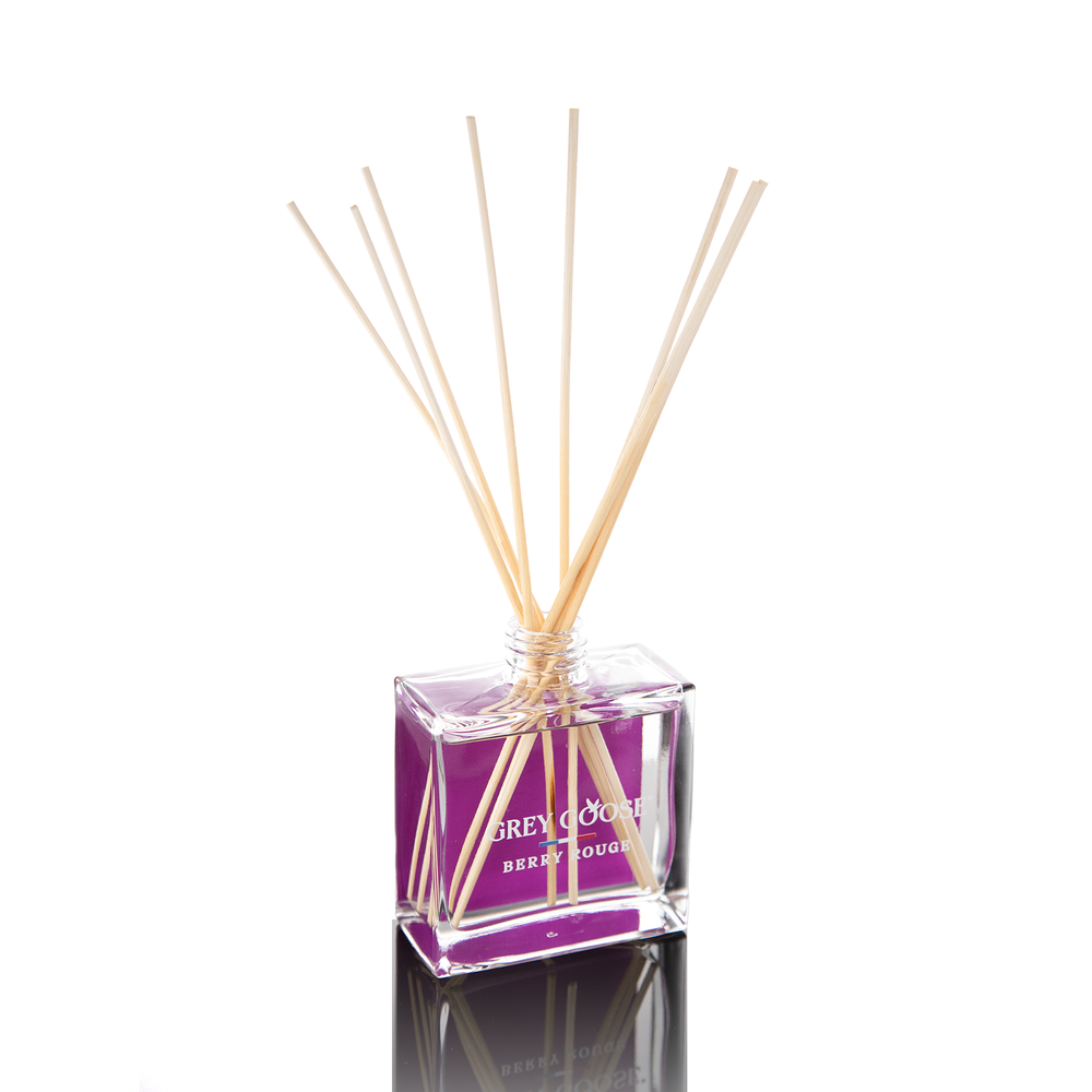 Clear glass 8 oz reed diffuser with a purple print and natural reeds