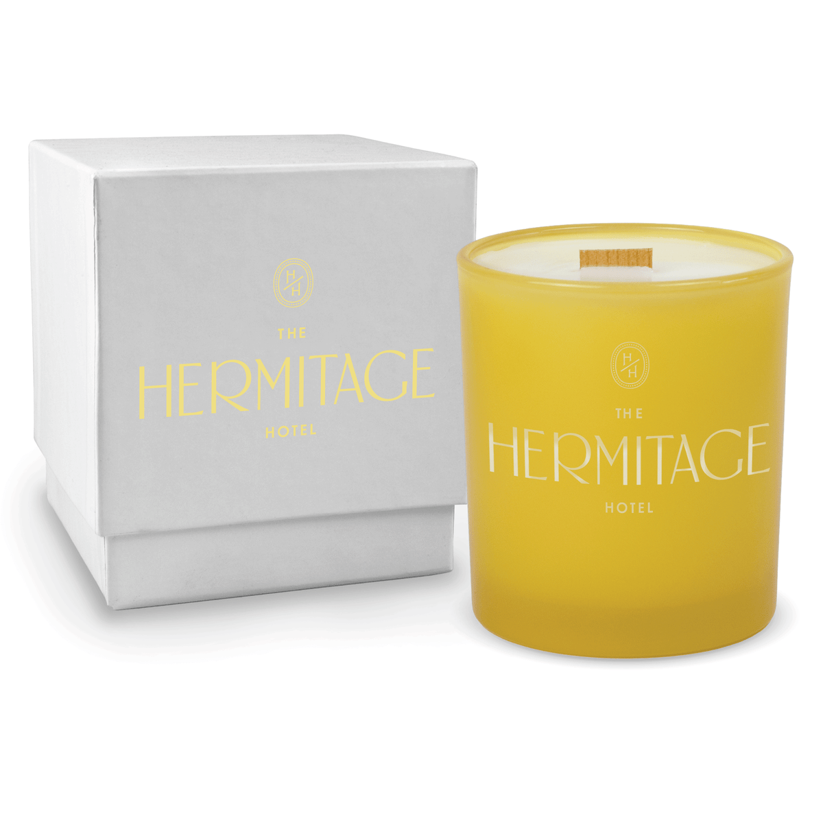 Yellow 14 oz colored glass engraved logo candle beside a glossy white gift box on a white background.