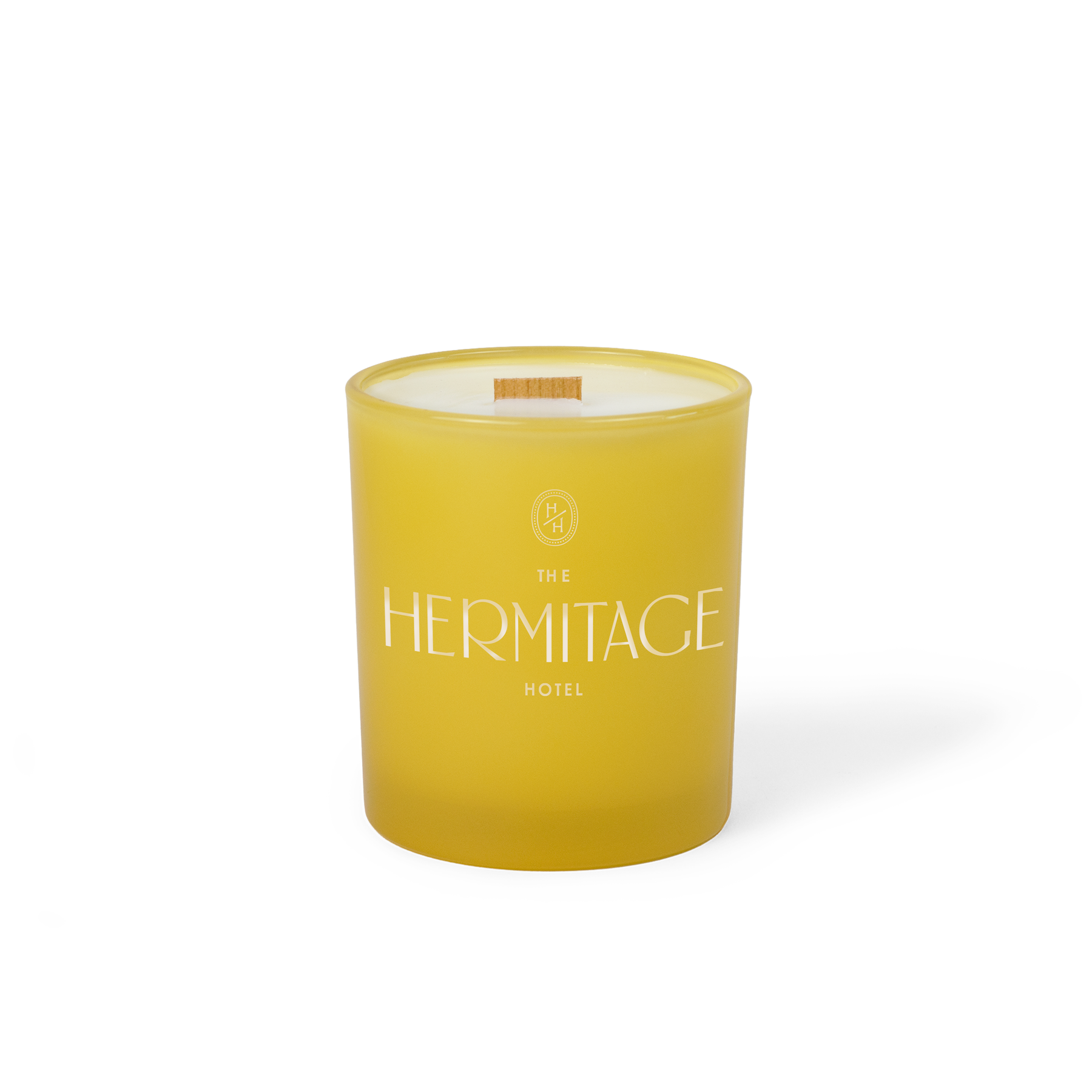 Yellow colored-glass 14 oz candle with an engraved brand logo, shown on its own.
