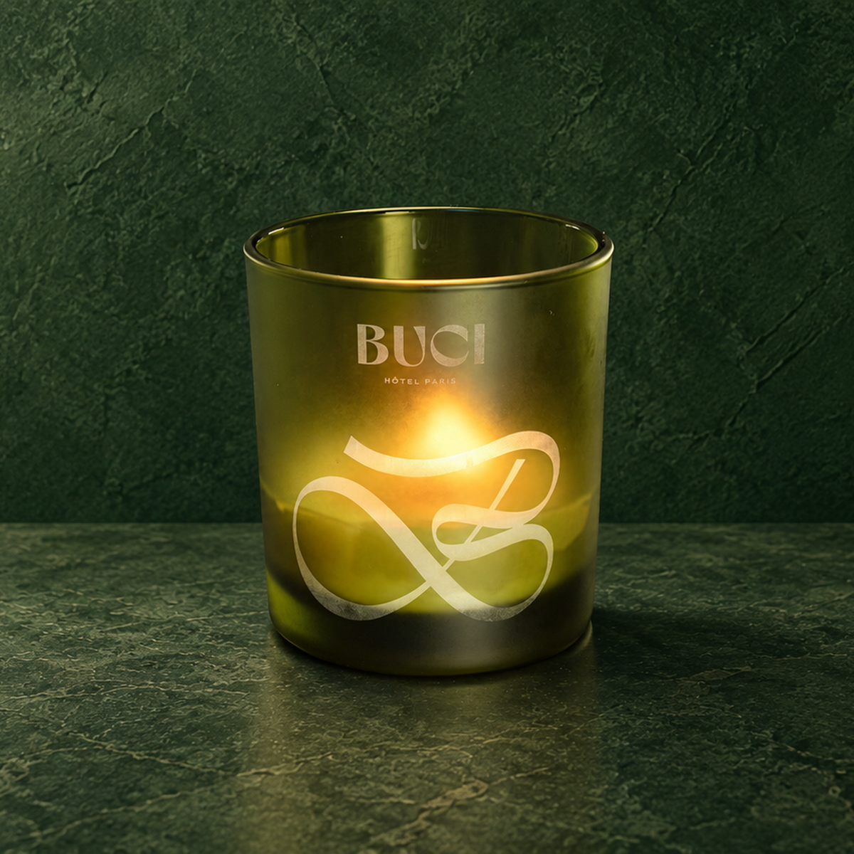 Green 14 oz. Luxury Engraved Candle with a custom engraved logo, lit.