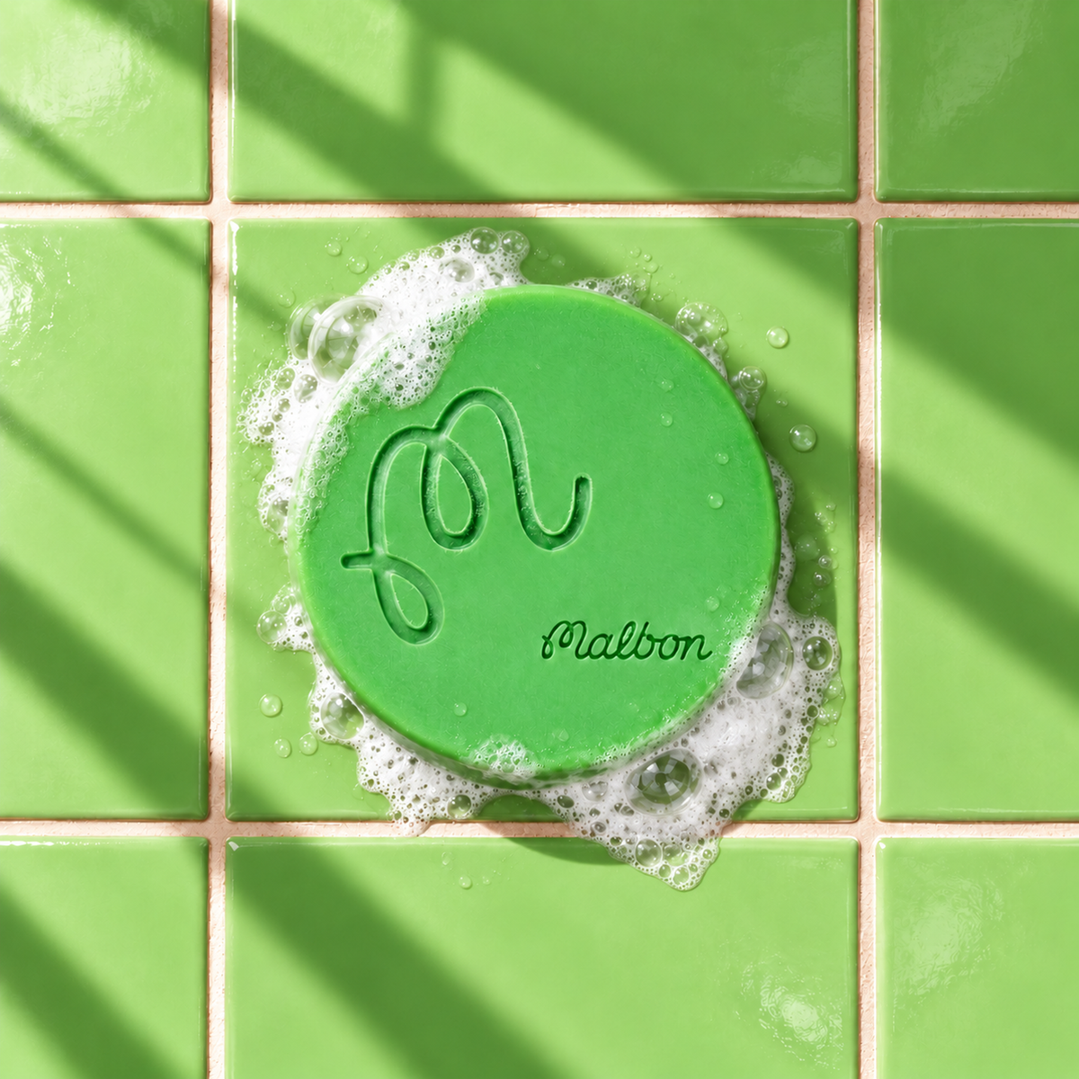 Green round bar soap laser engraved with a brand logo, 3.6 oz, with soap bubbles