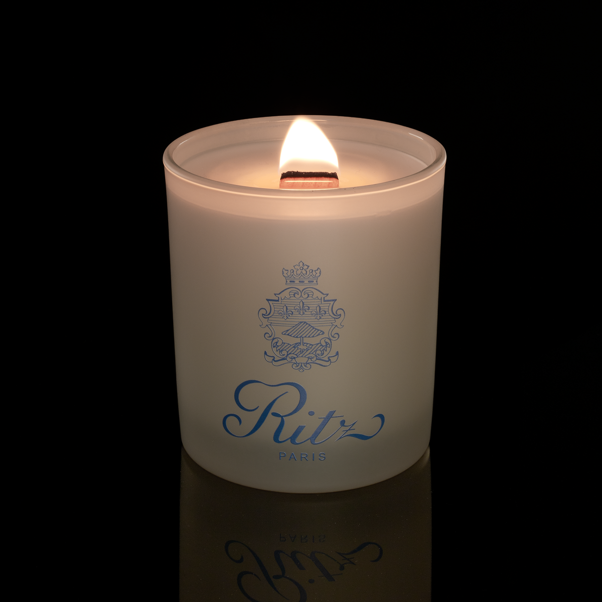 Ivory 14 oz. Luxury Printed Candle lit, shown on a black background.