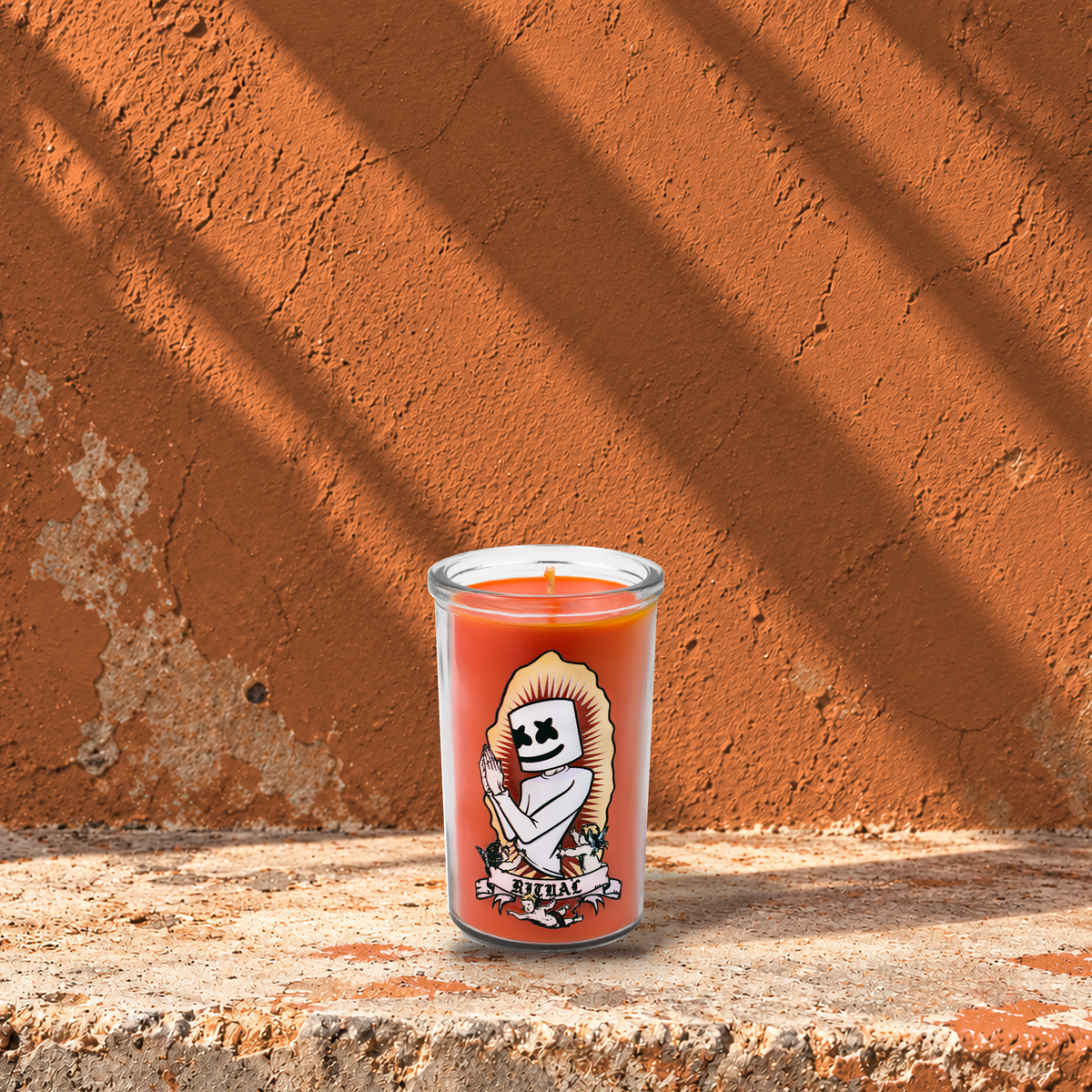 Orange 5 oz custom mini prayer candle printed with the Ritual logo on an orange background, unlit