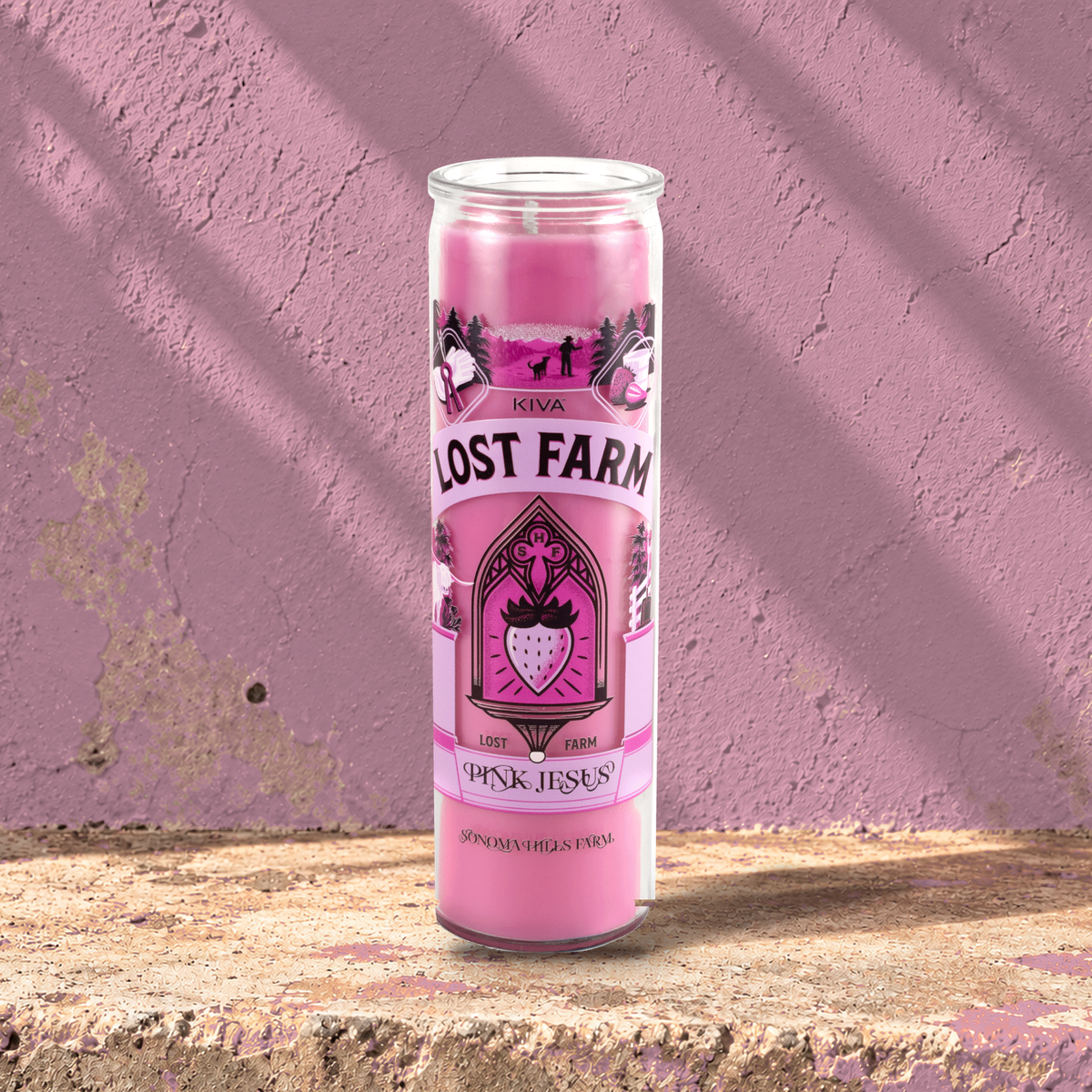 Pink 16 oz custom prayer candle printed with the Kiva Lost Farm logo on a pink background, unlit