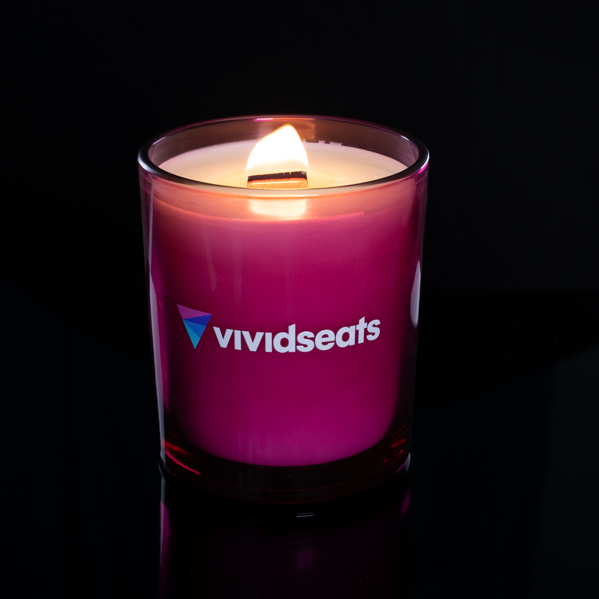 Purple 14 oz. Luxury Printed Candle lit, shown on a black background.