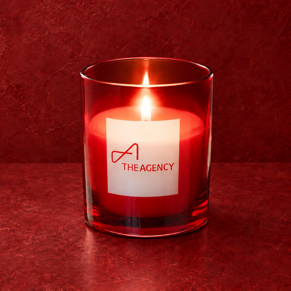 Red 9 oz. Classic Engraved Candle with a custom engraved logo, lit.