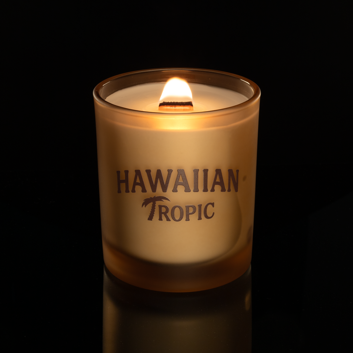 Sand 14 oz. Luxury Printed Candle lit, shown on a black background.