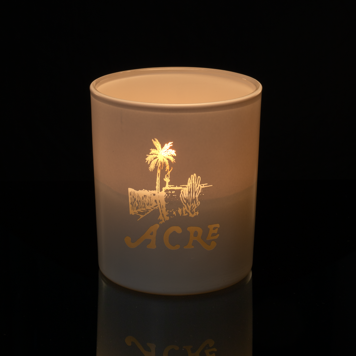Matte White 14 oz. Luxury Engraved Candle lit, shown on a black background.