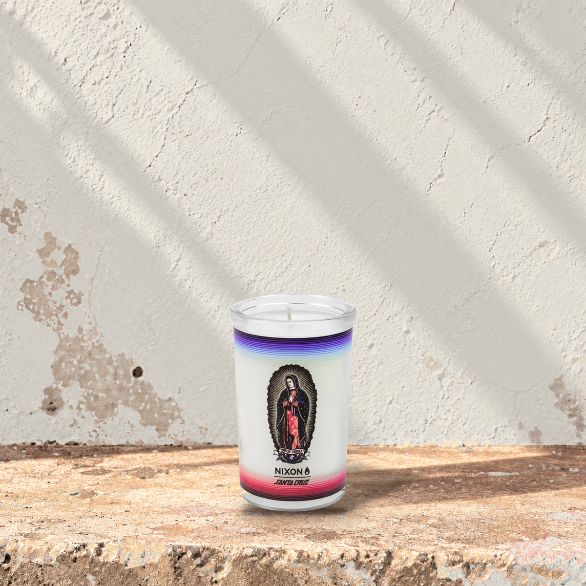 White 5 oz custom mini prayer candle printed with the Nixon Santa Cruz logo on a white background, unlit