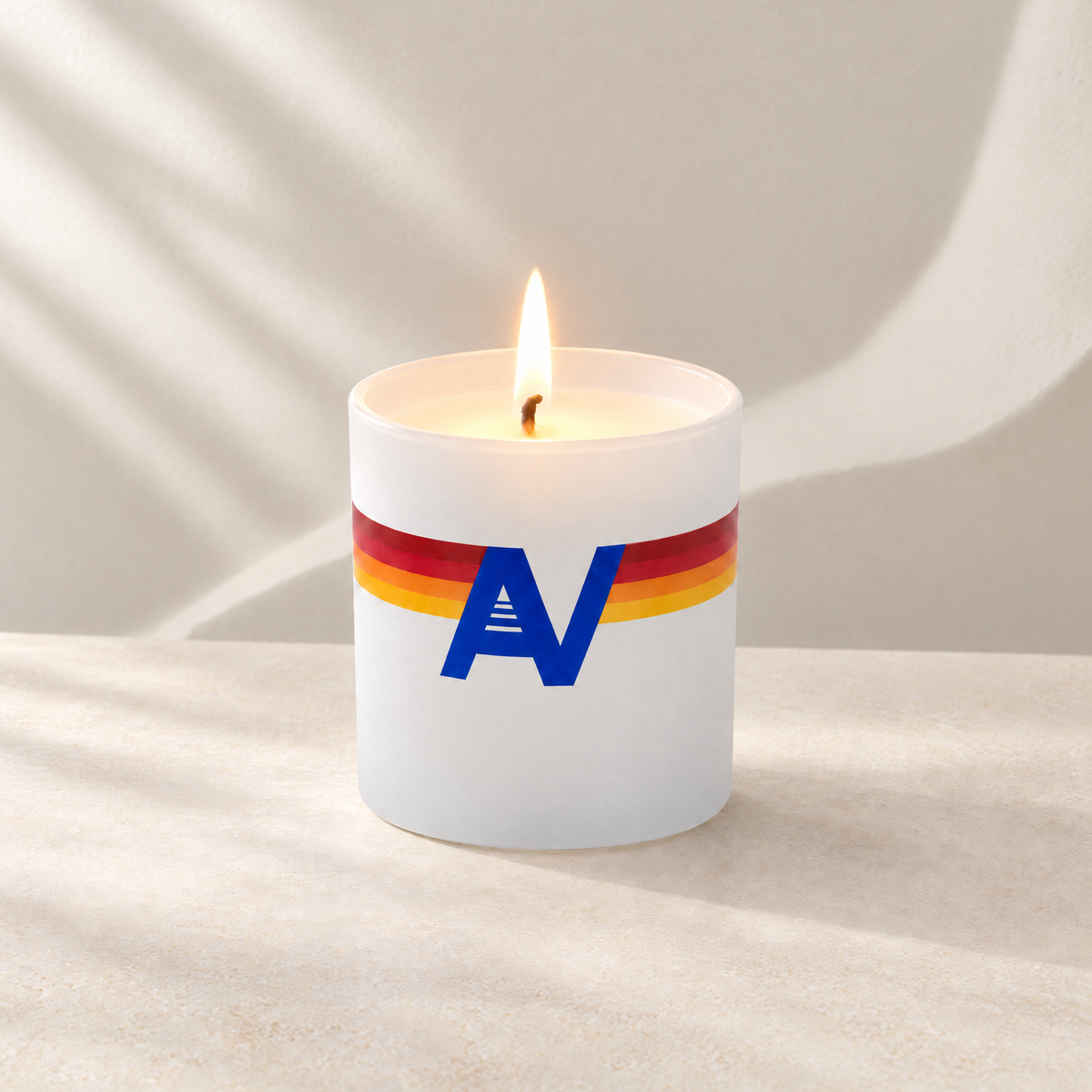 Matte White 9 oz. Classic Printed Candle lit with a printed custom logo, shown on a matching white background.