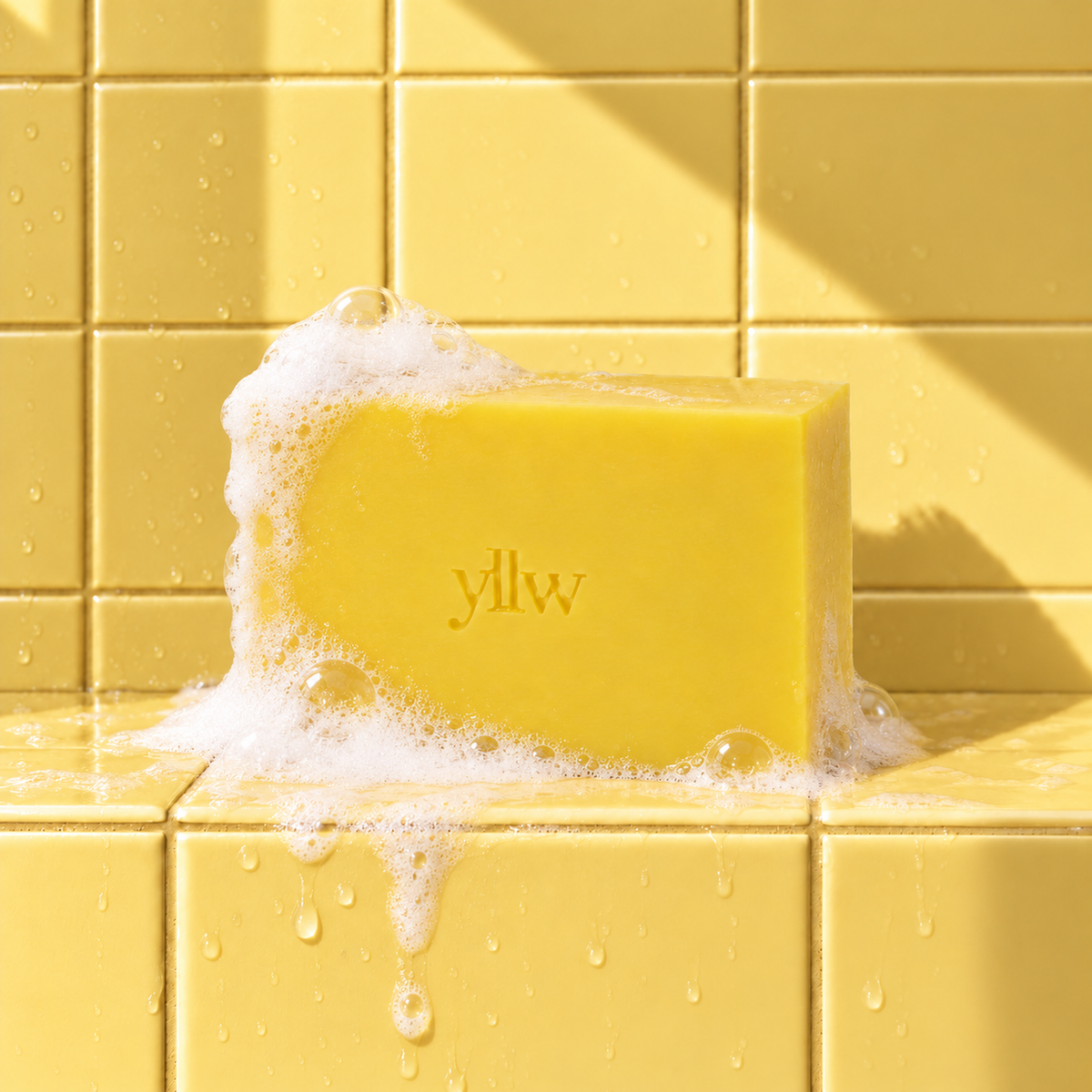 Yellow rectangle bar soap laser engraved with a brand logo, 3.25 oz, with soap bubbles