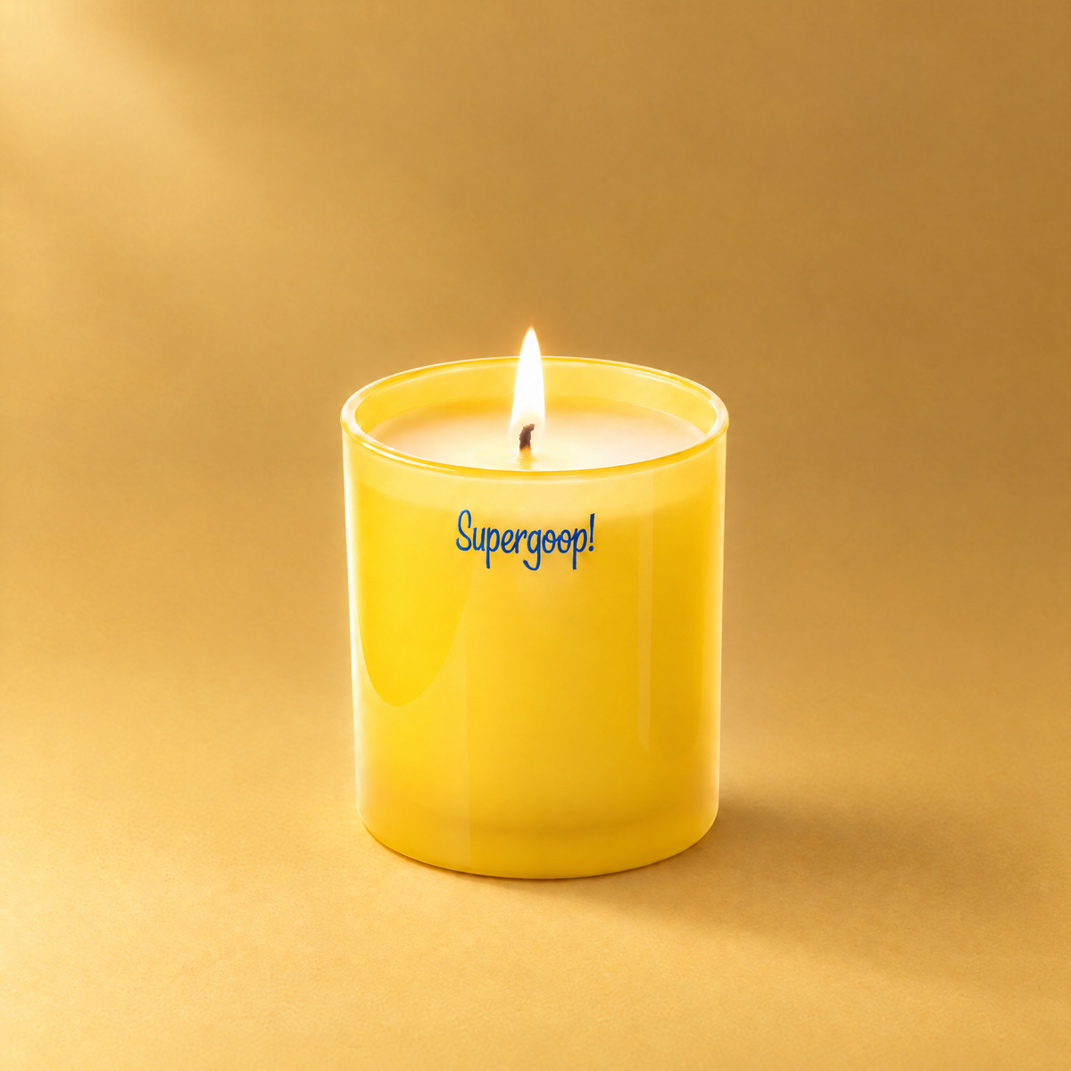Yellow 9 oz. Classic Printed Candle lit with a printed custom logo, shown on a matching yellow background.