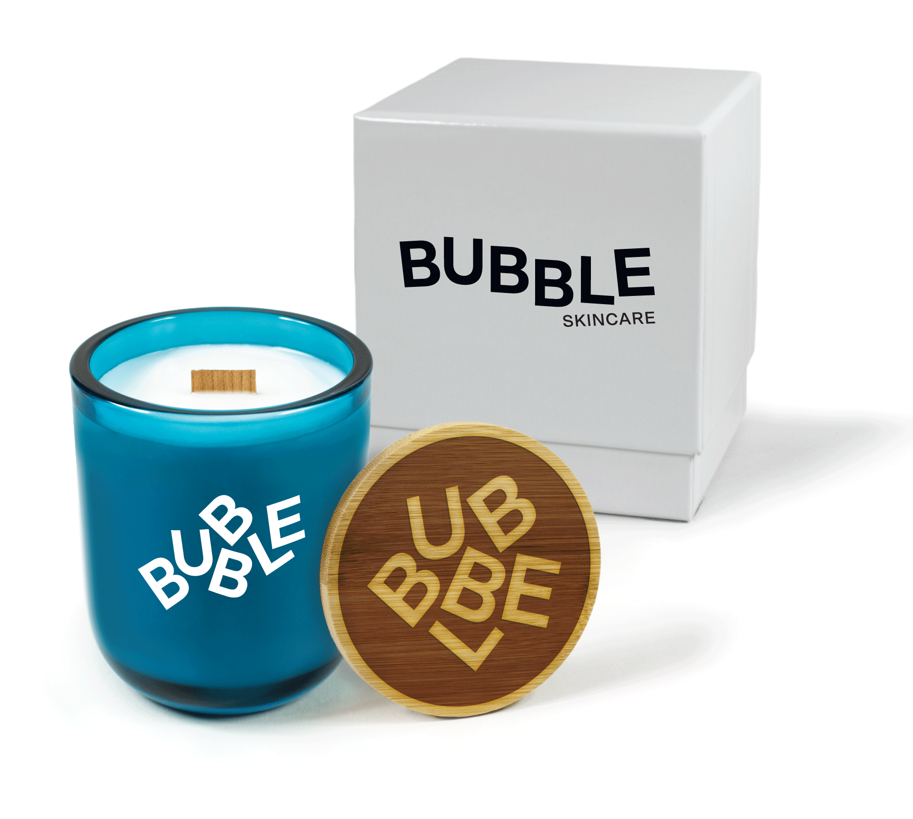 A 12 oz Luxe Custom Candle in the color “Oceania” which is a splashy teal from Custom Candles LA. The candle features a wood wick and white imprinted “BUBBLE” logo on the front of the glass. Leaning against the side of the candle is a bamboo candle lid reverse engraved with the “BUBBLE” logo. In the background, there is a white 2-piece box printed with a black “BUBBLE Skincare” logo.