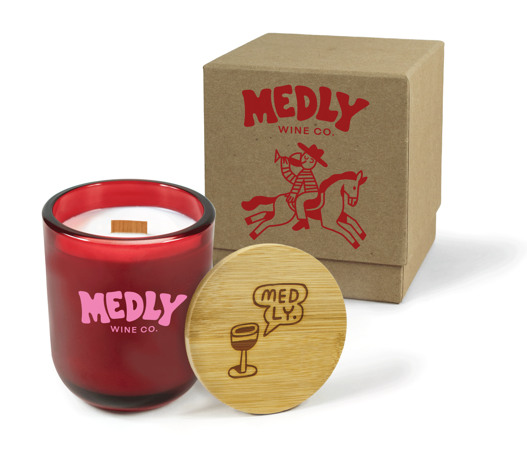 A 12 oz Luxe Custom Candle in the color “Blood Red” which is a vivid rouge red from Custom Candles LA. The candle features a wood wick and pink 4-color printed logo for “Medly Wine Co.” on the front of the glass. Leaning against the side of the candle is a bamboo candle lid etched with a wine glass and a speech bubble reading “Medly.” In the background, there is a kraft 2-piece box 4-color printed with a red “Medly Wine Co. logo above a cowboy riding a horse backwards while drinking wine.