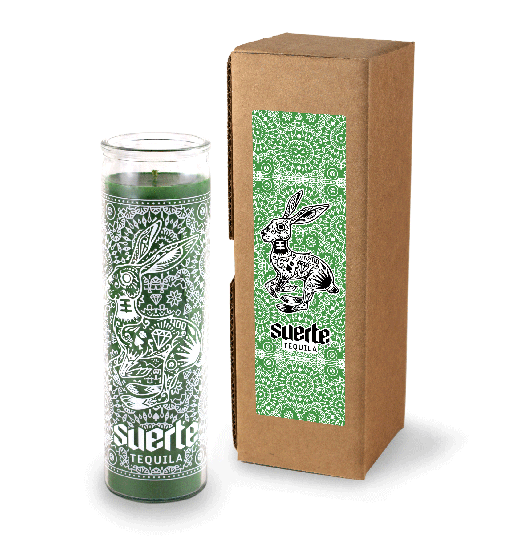 A 16 oz Prayer Candle from Custom Candles LA filled with green wax in a tall glass container. The candle is printed a logo at the bottom that reads "Suerte Tequila" in white. The logo is surrounded by an ornate pattern that makes the shape of a rabbit. The green wax shows through the artwork.To the right of the candle sits a Kraft mailer box with a sticker on it that is printed with the same logo and artwork but in black and has green line artwork surrounding it with a white background.