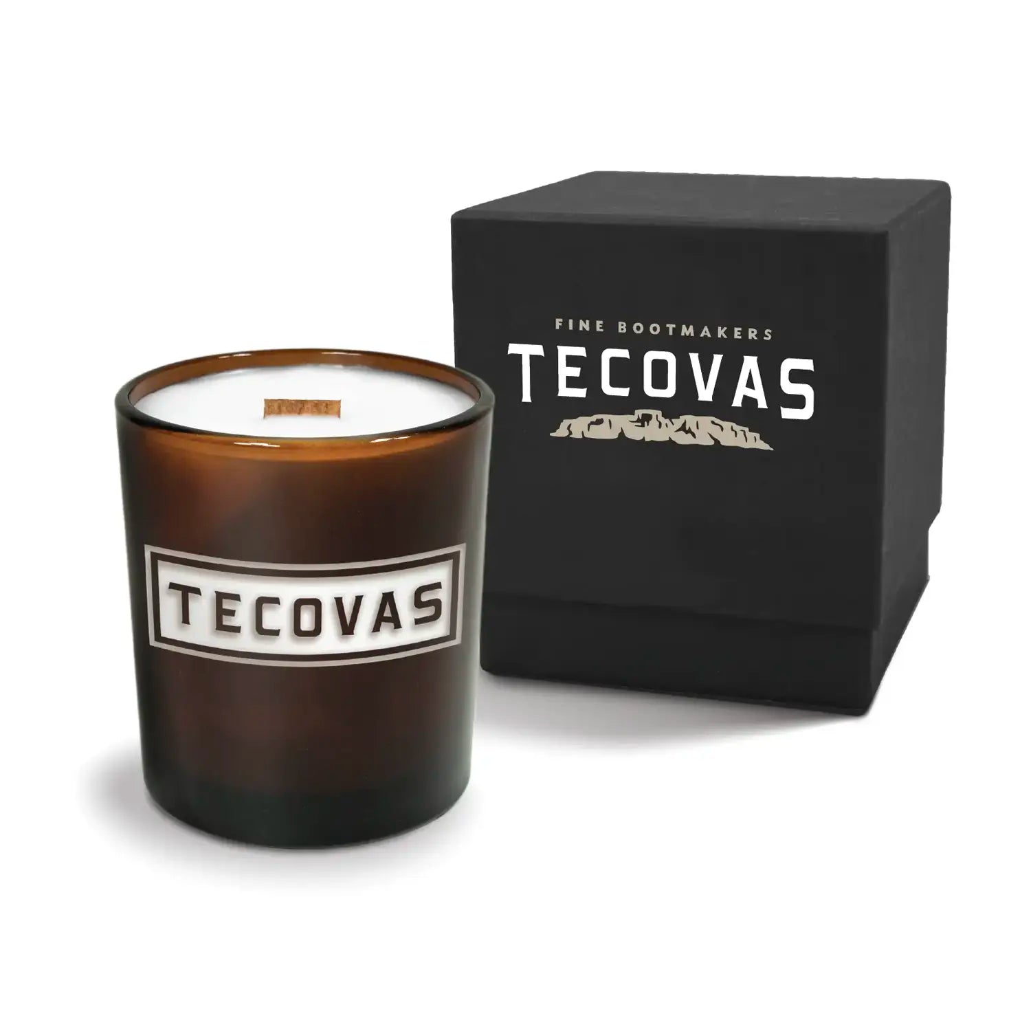 Luxury engraved candle with branding next to a box on a white background