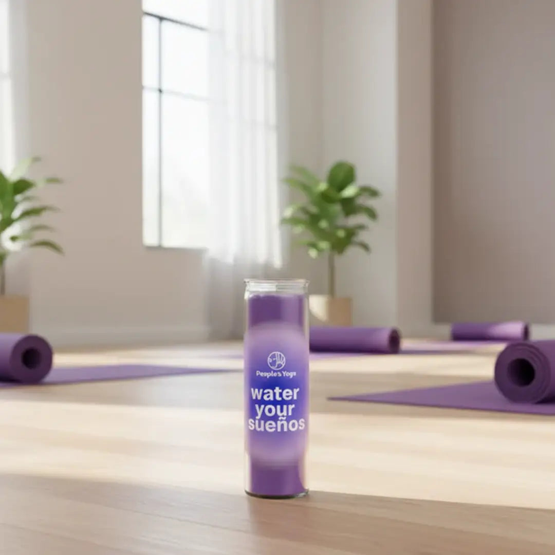 Purple water bottle with motivational text on a yoga mat in a room with windows and plants