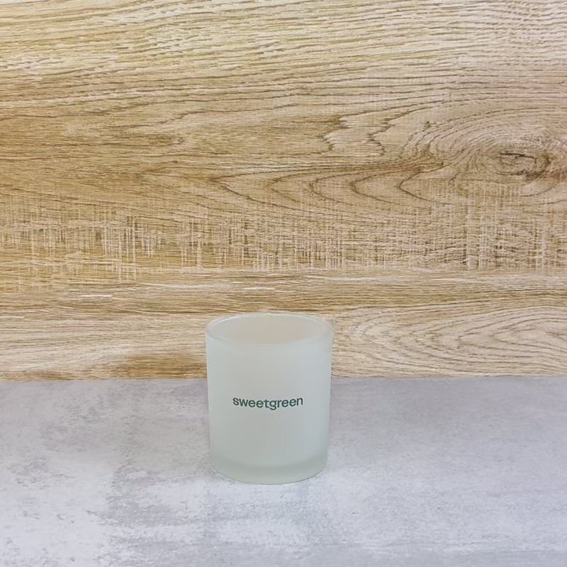 Load video: example video of how to reuse spent frosted candle glass as a planter after the wax has been melted