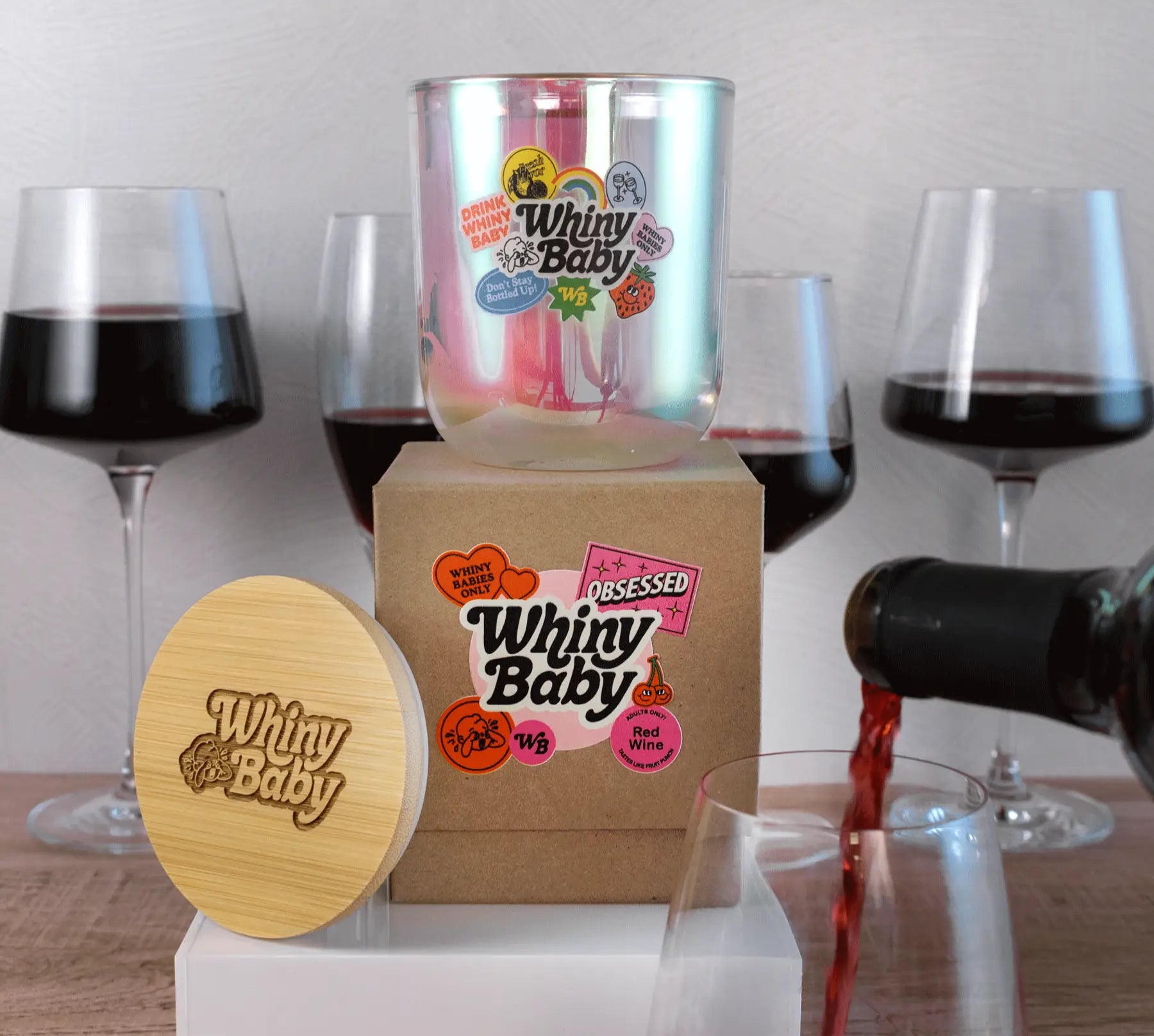 Wine glasses with logo branding on a wooden table.