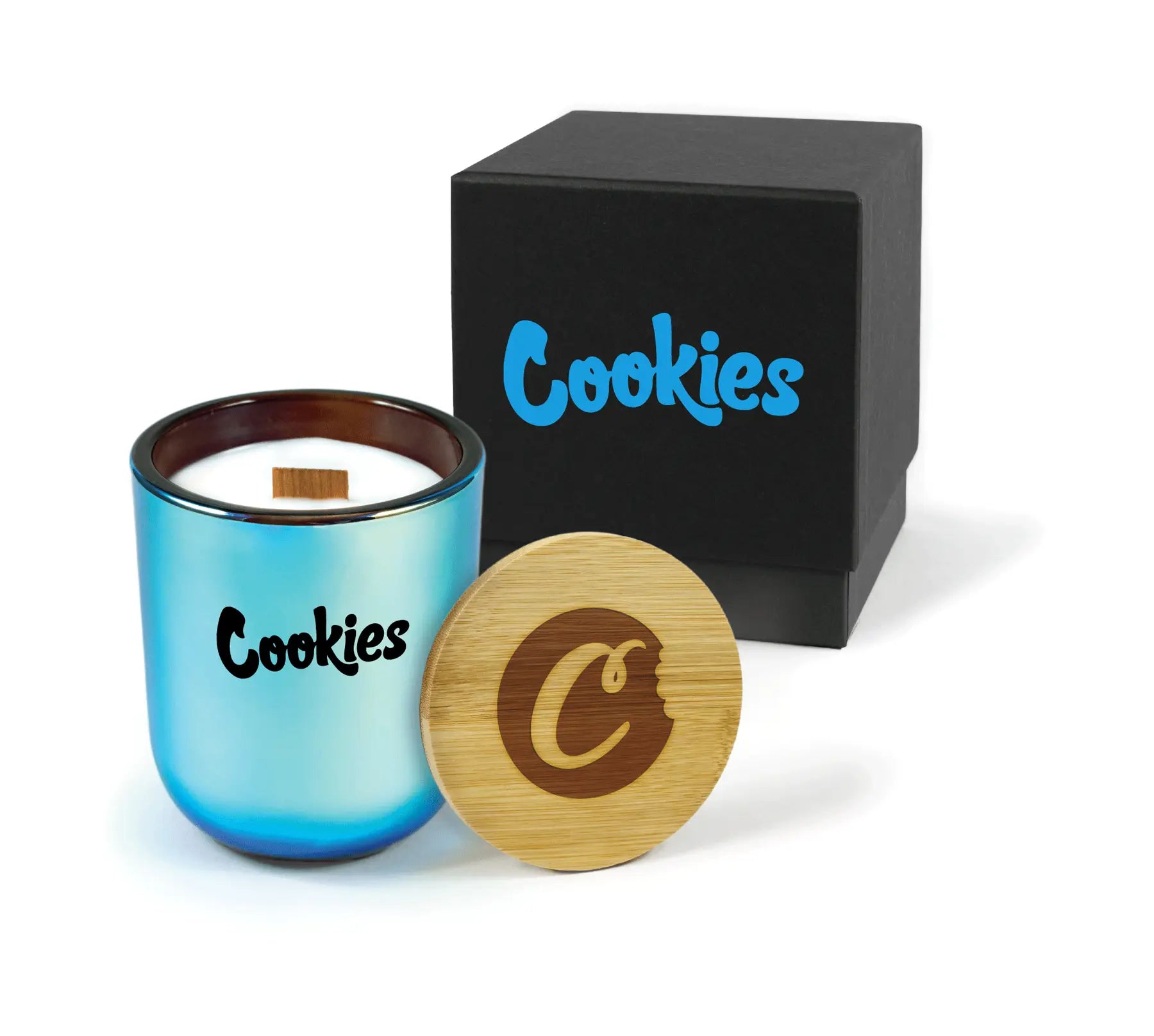 Blue candle with wooden lid and 'Cookies' branding next to a black box with branding on a white background.