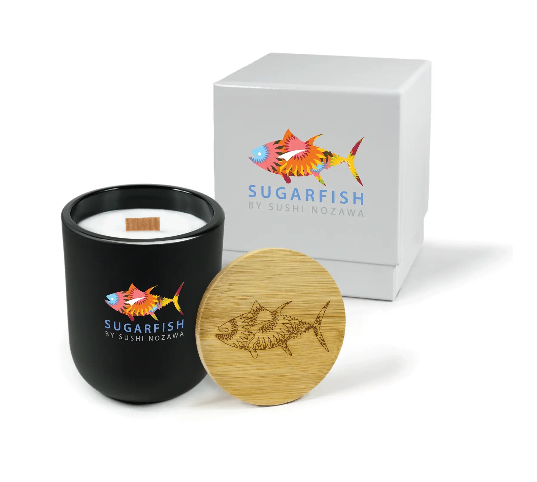 Black candle with wooden lid and 'Sugarfish' branding next to a white box with the same branding.