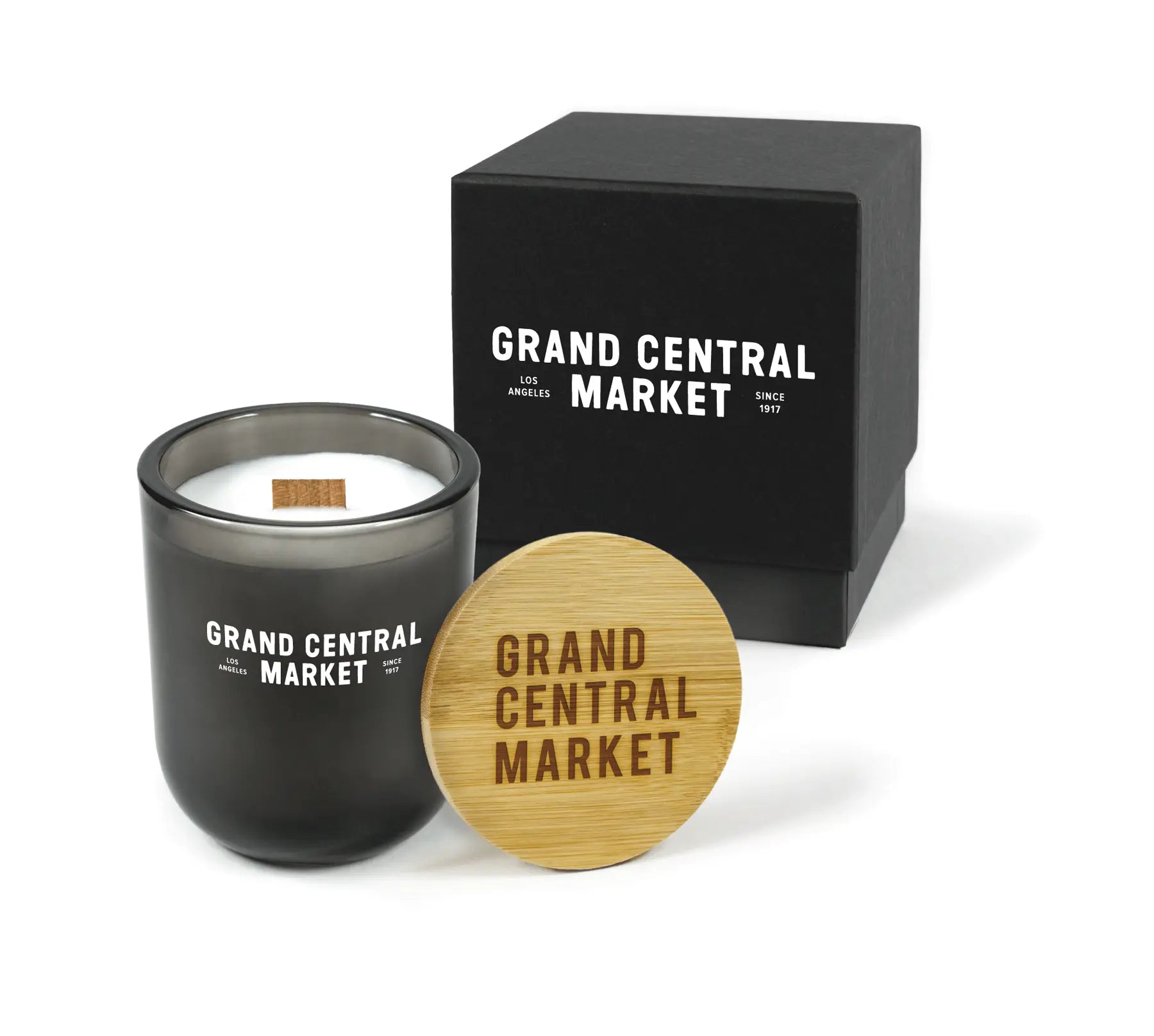 Black candle with wooden lid and branding on a white background