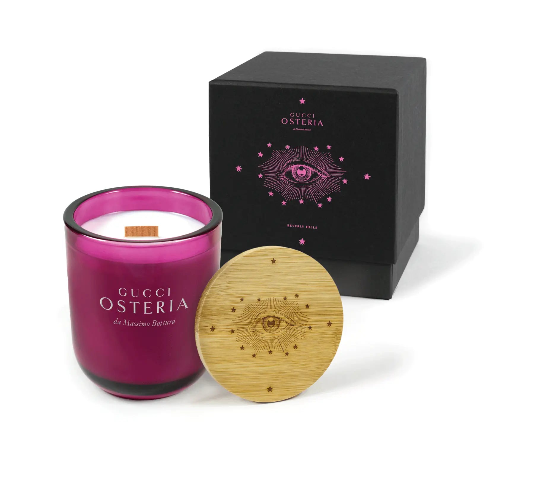 candle with pink glass and wooden lid next to a black box on a white background
