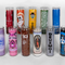 A collection of eleven colorful prayer candles in glass holders, each with unique designs, logos, or text, arranged upright in two rows on a gray background.