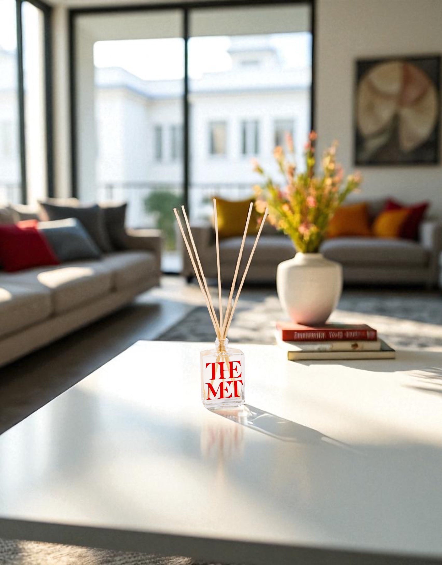 Decorative diffuser with 'The Met' branding on a coffee table in a living room.