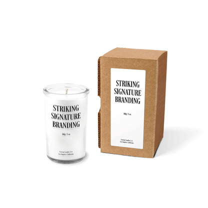 White wax 5 oz mini prayer candle sample with a printed brand logo and kraft gift box