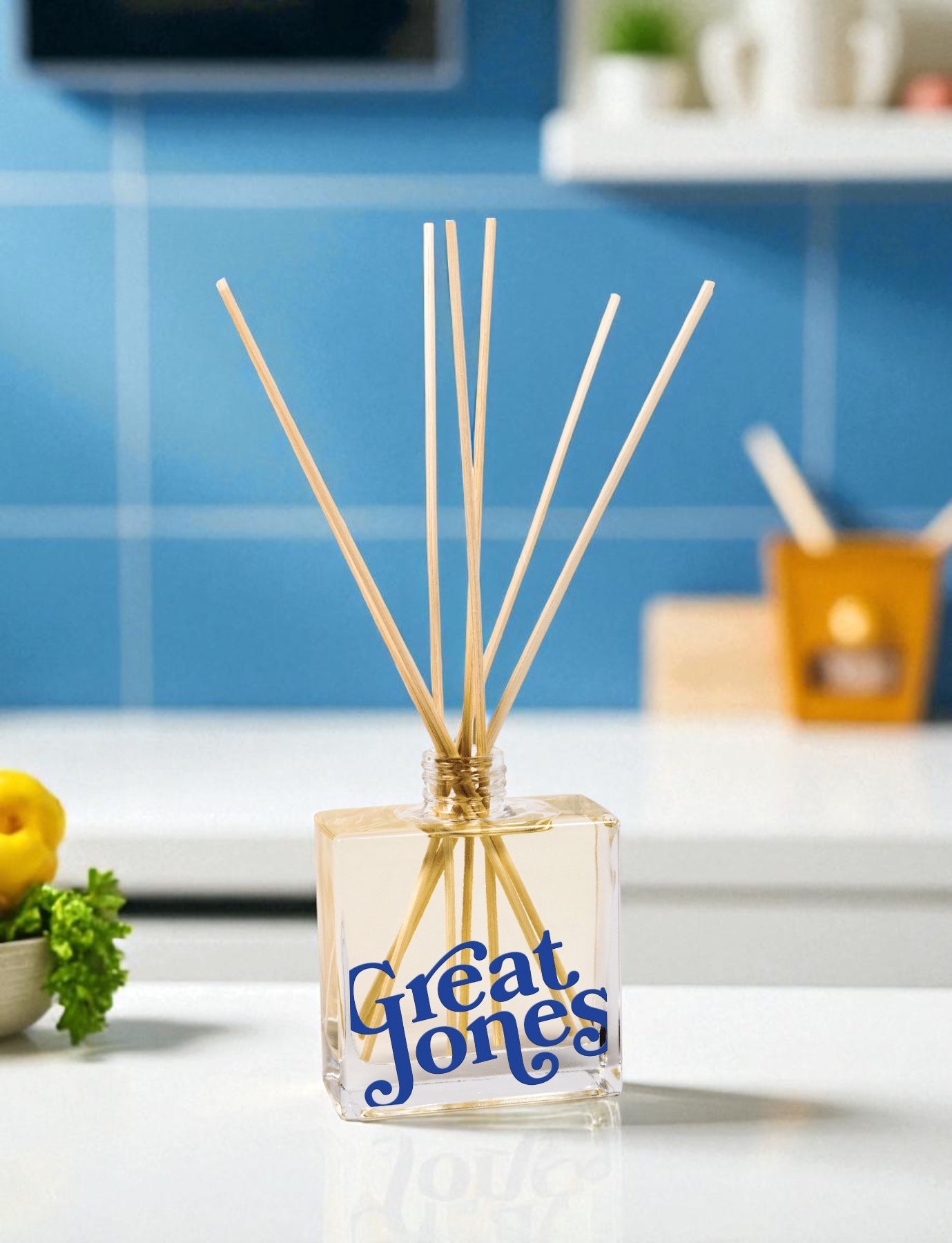 Reed diffuser with 'Great Jones' branding on a kitchen counter.