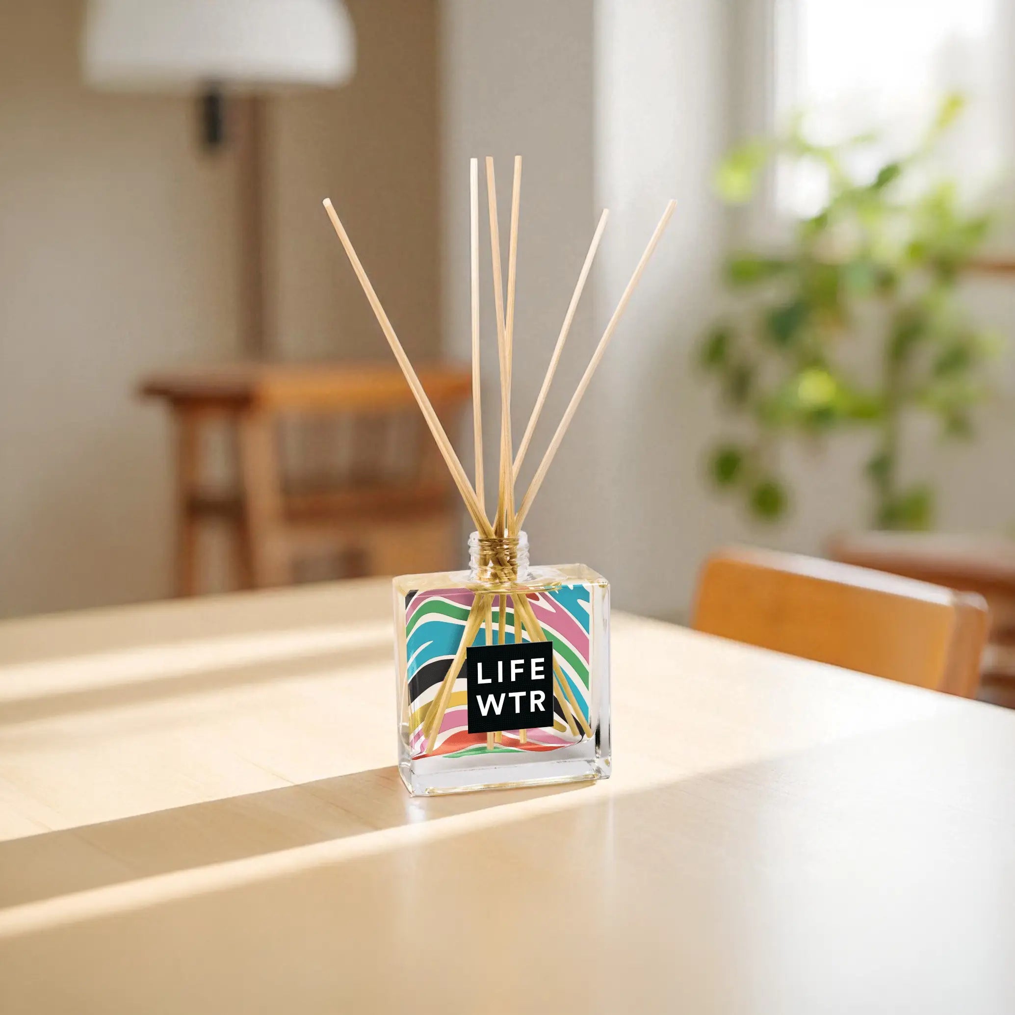 Clear 8oz Reed Diffuser with sticks on a table in a bright room.