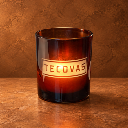Glossy Amber 14 oz. Luxury Engraved Candle with a custom engraved logo, lit.
