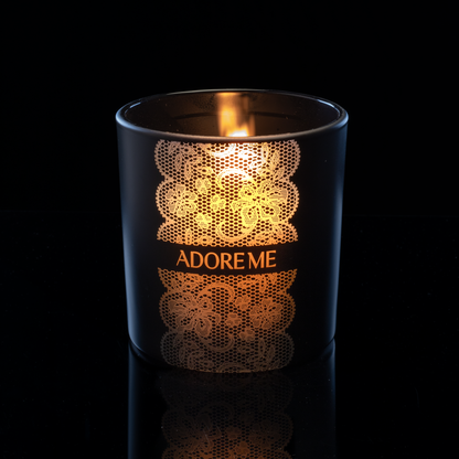 Matte Black 14 oz. Luxury Engraved Candle lit, shown on a black background.