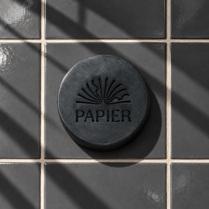 Black round bar soap laser engraved with a brand logo, 3.6 oz
