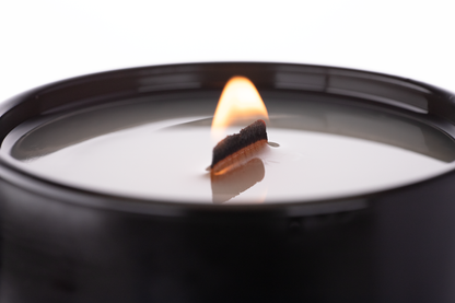 Matte Black 14 oz. Luxury Printed Candle burning, close-up of the flame and wax pool.