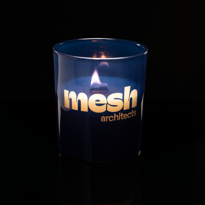 Blue 14 oz. Luxury Engraved Candle lit, shown on a black background.