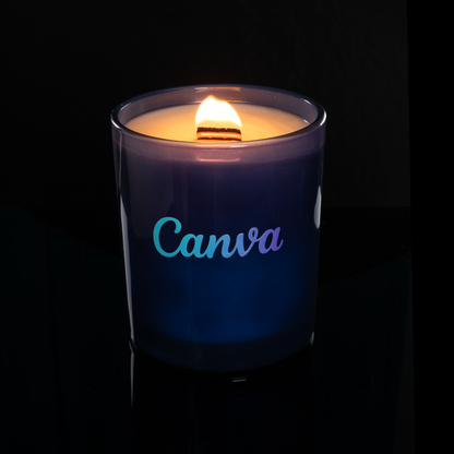 Blue 14 oz. Luxury Printed Candle lit, shown on a black background.