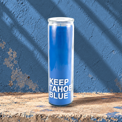 Blue 16 oz custom prayer candle printed with the Keep Tahoe Blue logo on a blue background, unlit