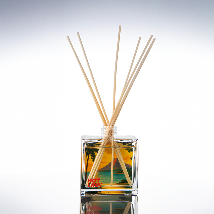 Clear glass 8 oz reed diffuser printed with a tropical sunset design, natural reeds