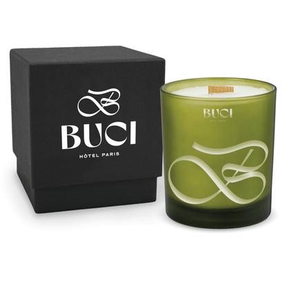 Green 14 oz colored glass engraved logo candle beside a matte black gift box on a white background.