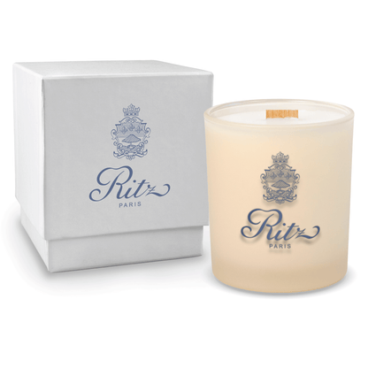 Ivory colored-glass 14 oz candle beside a glossy white gift box.