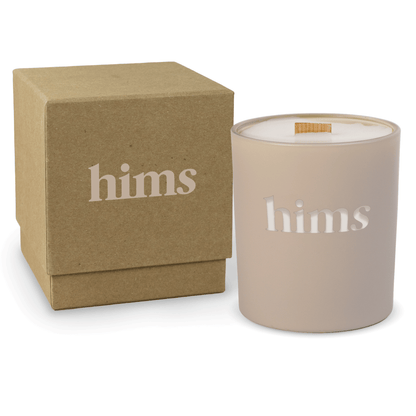 Nude 14 oz colored glass engraved logo candle beside a kraft gift box on a white background.