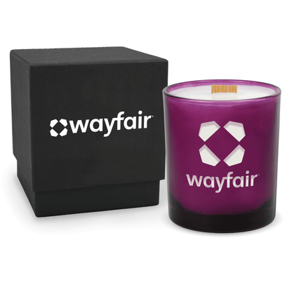 Purple 14 oz colored glass engraved logo candle beside a matte black gift box on a white background.