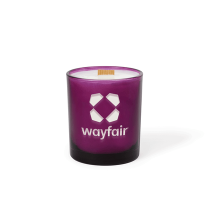 Purple colored-glass 14 oz candle with an engraved brand logo, shown on its own.