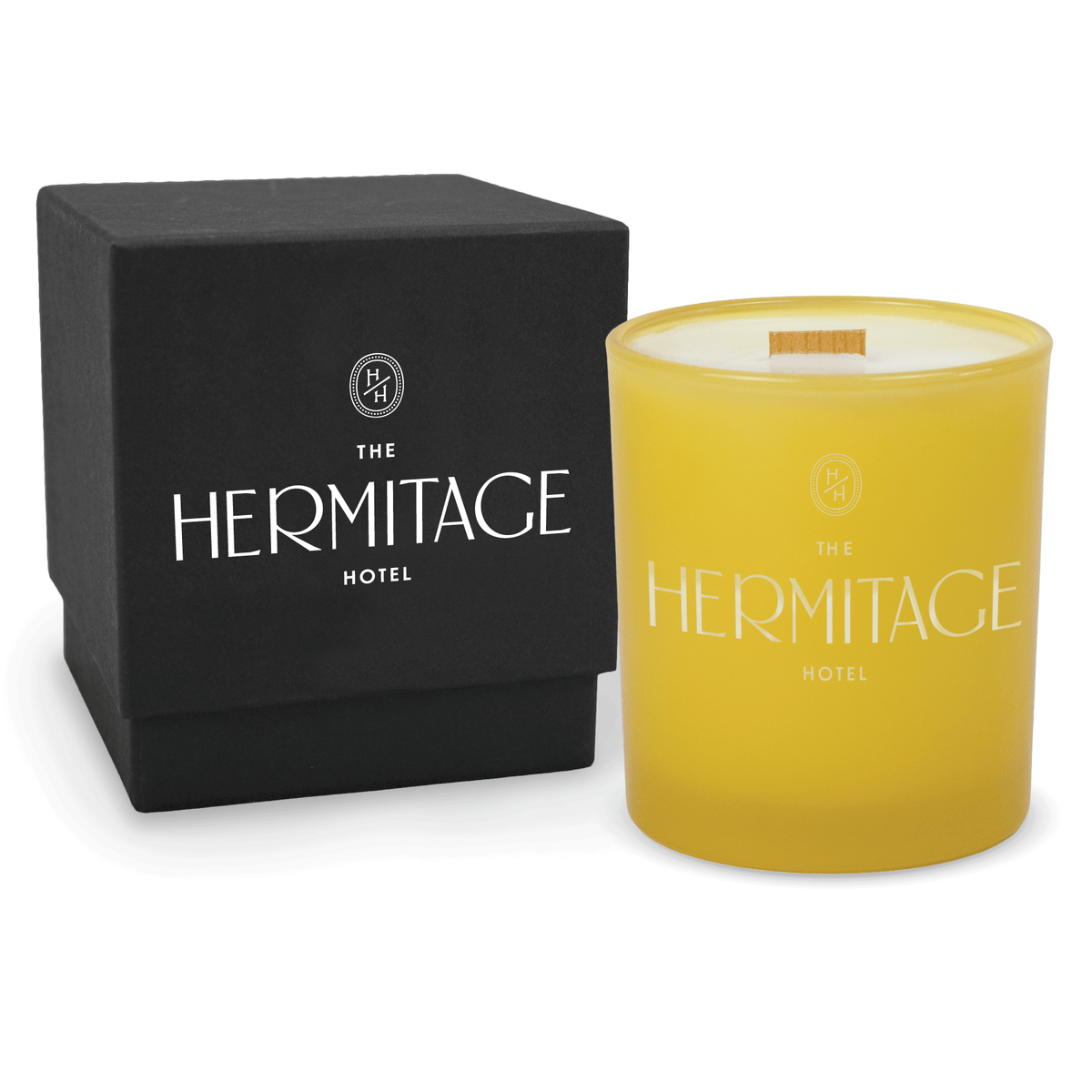 Yellow 14 oz colored glass engraved logo candle beside a matte black gift box on a white background.