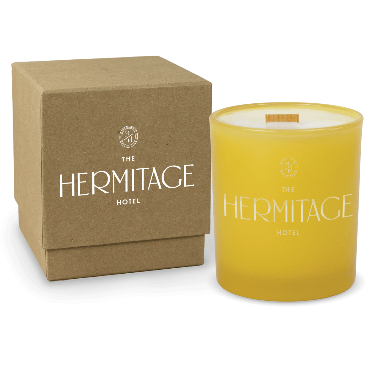 Yellow 14 oz colored glass engraved logo candle beside a kraft gift box on a white background.